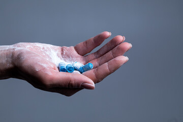 Fototapeta premium Female hand holds capsule. Capsule. Pills. Background. 