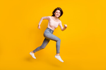 Fototapeta na wymiar Full size profile side photo of young happy positive lovely woman running in air isolated on yellow color background