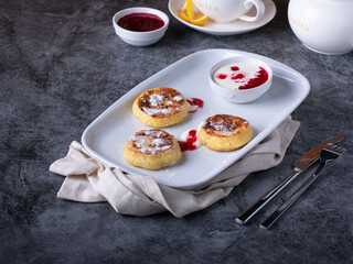 Pancakes topped with whipped cream, raspberry jam. Sweet dessert for breakfast