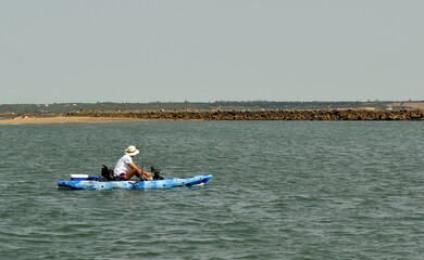 A person in a kayak fishing in the sea 