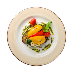 grilled vegetables on a plate with pesto sauce top view isolated on white background