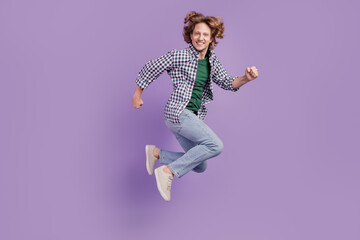 Full body profile side photo of young man good mood jump runner wear casual outfit isolated over violet color background