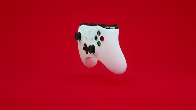 Game joystick on a red background. Console gamepad controller rotating on a red background