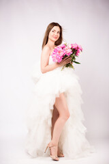 Fototapeta premium Beautiful young woman with delicate peony flower.