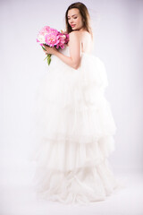 Fototapeta premium Beautiful woman fashion model makeup with blossom peonies.