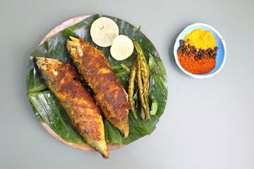 Indian Mackerel fish fry. Bangda Rava fry. whole Fried fish served on a banana leaf with fried...