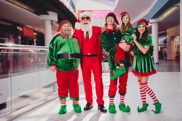 Photo of funny people x-mas advent concept glad smile wear santa elf costume in supermarket mall center