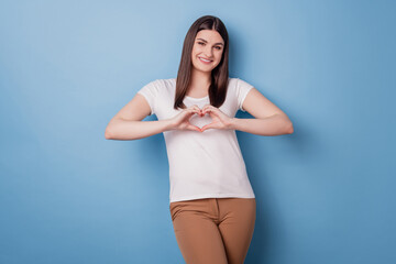 Portrait of adorable girlfriend cute lady show heart gesture toothy smile on blue background