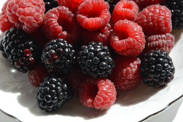 ripe, fresh berries. Raspberries and blackberries on a white background. vitamin dessert.