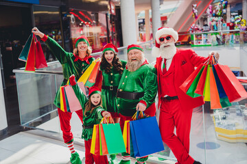 Portrait of attractive cheerful cool group elfs buying gifts spending eve advent festal day time at shopping mall indoors