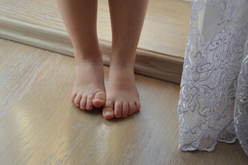 small bare children's feet on the light floor. background for the design.
