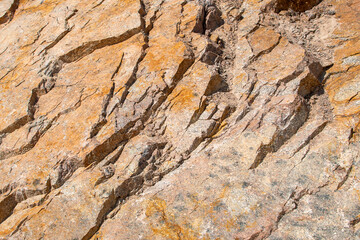 Raw rough yellow golden brown granite texture background. Natural rock stone texture background. Granite Grades. Muscovite colored minerals in granite