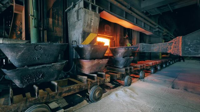 Molds are getting put into a furnace by an industrial loader