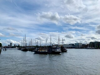 View from Tower Bridge Wharf to Thames river. Beautiful cloudy sky above London. Horizontal. Selective focus.