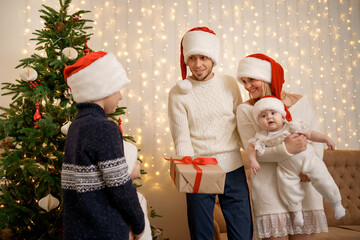 Obraz premium Christmas Family. Happiness. Portrait of dad, mom two daughters and son having good times together