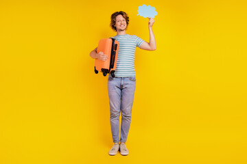 Full size photo of young man bag travel vacation hold bubble information isolated over yellow color background