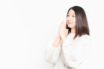 お願いのジェスチャーをする主婦