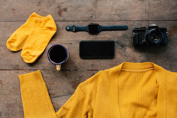 Neatly arranged modern equipment and winter clothes. Isolated on a wooden table. 