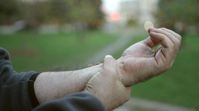 Elderly Man Having Wrist Pain Suffering  Outdoors Closeup