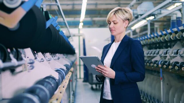 Female inspector is supervising a sewing machinery complex
