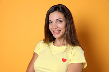 Obraz premium Portrait of beautiful woman on yellow background