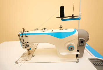 At the workshop. Electric sewing machine placed on a work table