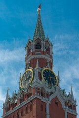 Obraz premium View of the Kremlin tower with chimes against a blue sky with light clouds, vertical Moscow photo