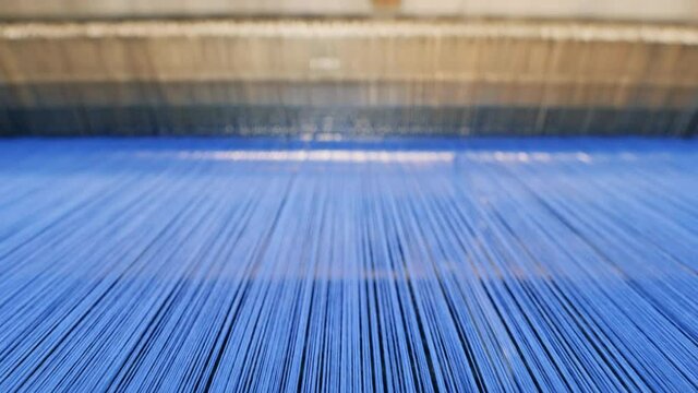 Lines of coloured threads inserted into a weaving machine