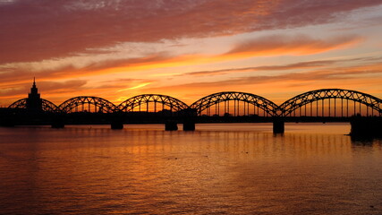 Fototapeta na wymiar Railway bridge in Riga against the background of dawn in autumn.