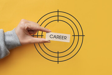 A wooden plate with the inscription: career in the center of the target. The goal in a person's...