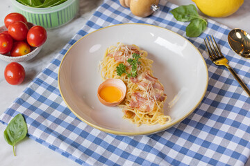 Spaghetti Carbonara on blue gingham fabric