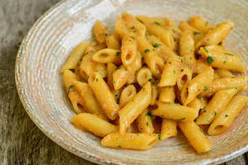  Italian home made   pennette pasta with smoked salmon , creamy sauce and fresh dill on wooden background