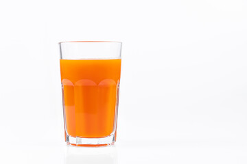 Pumpkin juice in transparent glass isolated on white background. Vegetable vegetarian drink. Healthy food and diet.