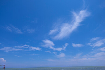 Naklejka na ściany i meble The blue sky had white clouds scattered all around.