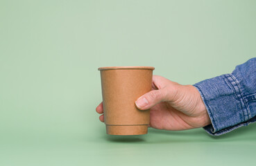 Hand holding paper cup with copy space.  Recycle and Save the World concept