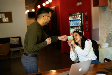 Colleagues in office. Businesswoman and businessman discussing work in office.