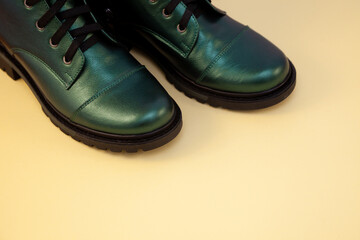 Green boots. Casual shoes classic. Leather modern boots. Boot with laces. Women's winter boot. Shoe. Copy space.