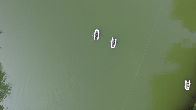 Aerial view small boats in lake water. Drone fly from Parz lake(Parz lich) in Armenia.  green forest and lake. Famous, Hiking place. Discovery Armenia.