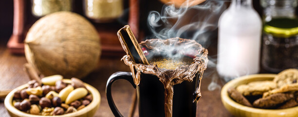 Vegan Christmas drink served hot, made with cocoa, cinnamon, vegan chocolate, hazelnuts and chestnuts.