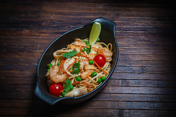 Asian style- restaurant background. Udon noodles with beef Wok