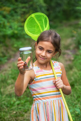 The child catches butterflies in nature. Selective focus. ,