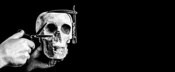 Still life skull with shaving tools. Barber shop tool on black background with copy space. Copy space. Black and white