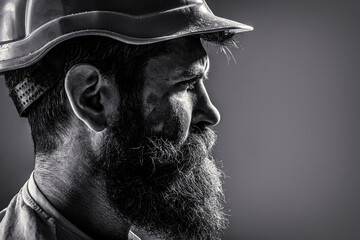 Bearded man worker with beard in building helmet or hard hat. Man builders, industry. Builder in...
