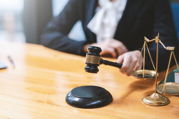 Close-up of a lawyer or businesswoman holding a mallet working at the office.