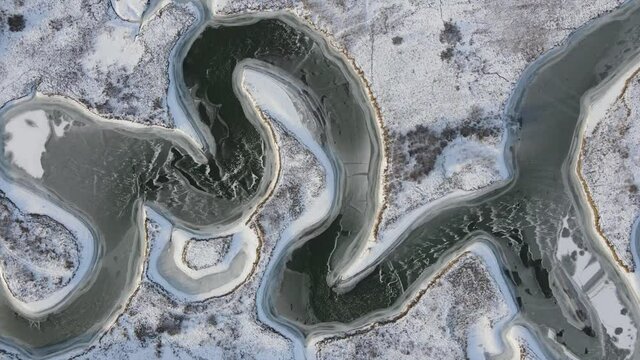 flying a drone in winter over a frozen river