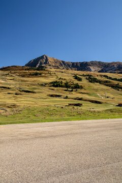 A Really Nice Mountain With A Blue Sky And A Piece Of Asphalt Without A Car