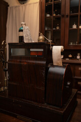 Vintage cash register in old pharmacy. Wooden antique furniture for medical drug storage