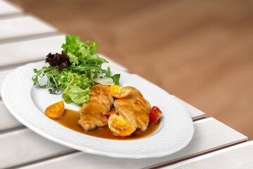 Dum chicken biriyani, serving bowl and garnished on the desk