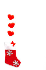 Merry Christmas. Santa Claus sock with saddles on white background Happy New Year flat lay