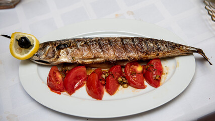 Fried fish with vegetables. Serving fish dishes. Close-up
